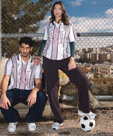 White shirt with red and black patterns on a grassy area, followed by two people sitting on a couch outdoors.
