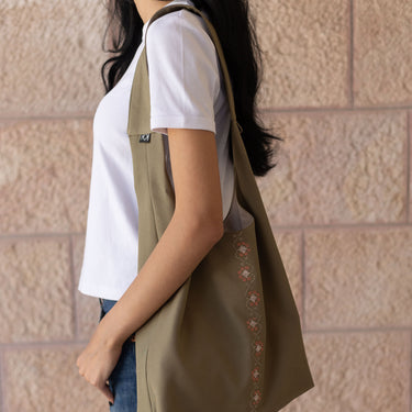 KUVRD Folklore Olive Tatreez bucket bag with handmade Wardah floral embroidery