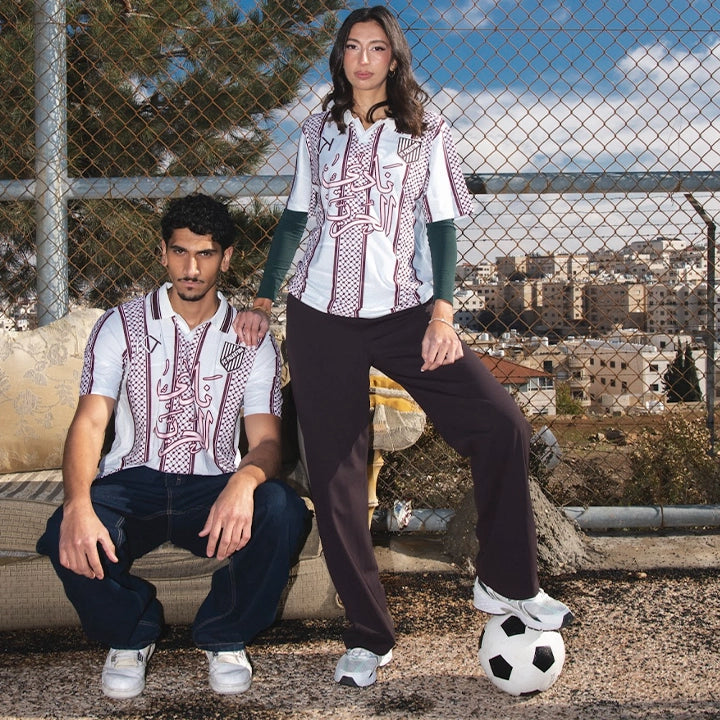 White shirt with red and black patterns on a grassy area, followed by two people sitting on a couch outdoors.