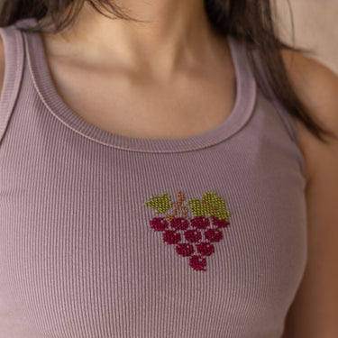 Close-up of grape (enab) tatreez embroidery on the KUVRD tank