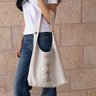 KUVRD Folklore Bone Tatreez bucket bag with handmade Palestinian floral embroidery