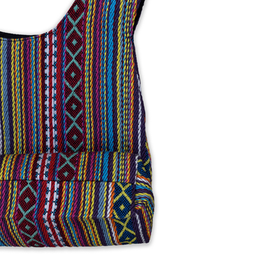 Colorful woven bag with geometric patterns on a white background