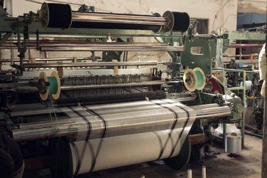 Traditional loom weaving an authentic Palestinian keffiyeh in our family-owned factory in Jordan — three generations of craft.